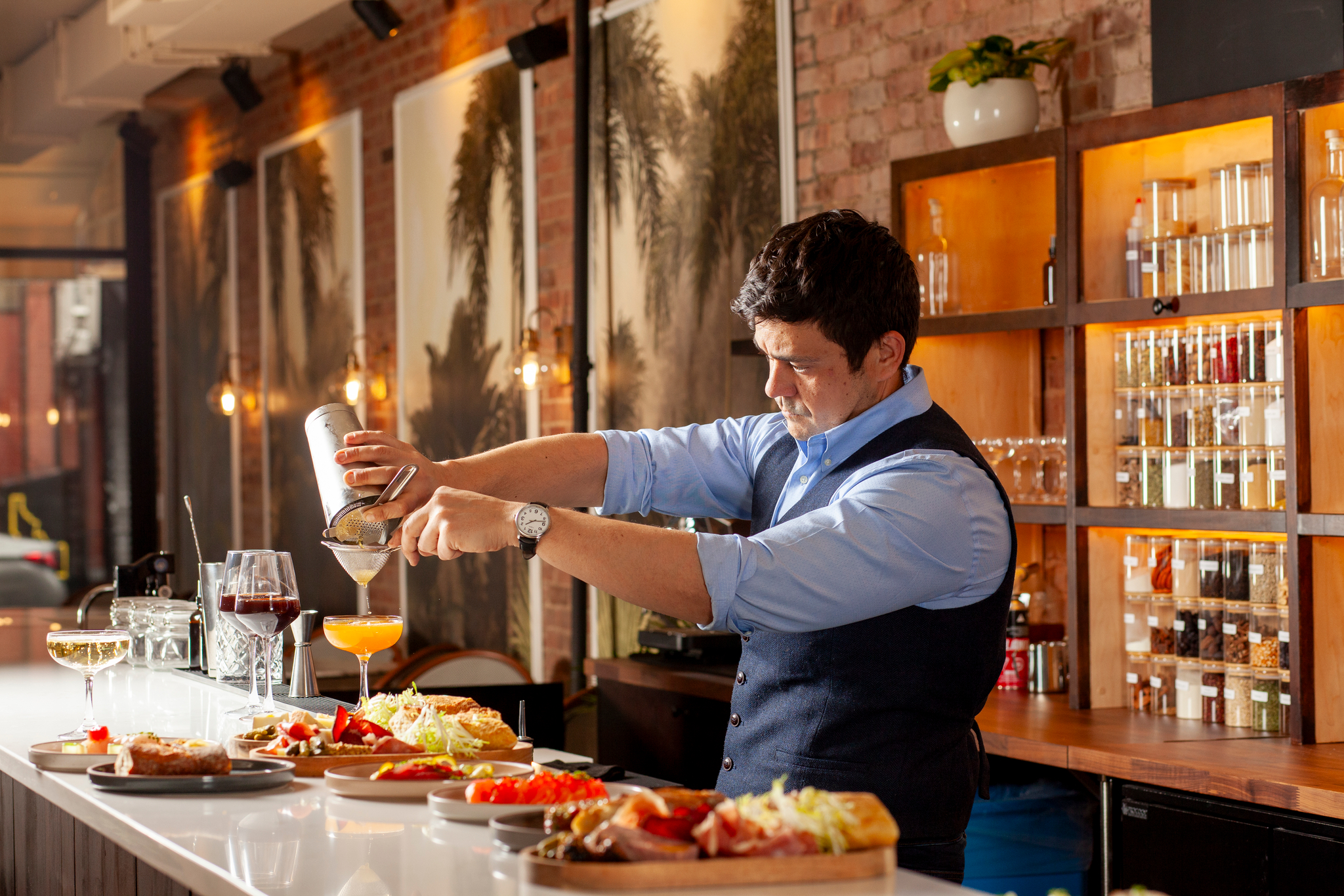 Rodrigo Nogueira straining a cocktail at the No More Cafe bar